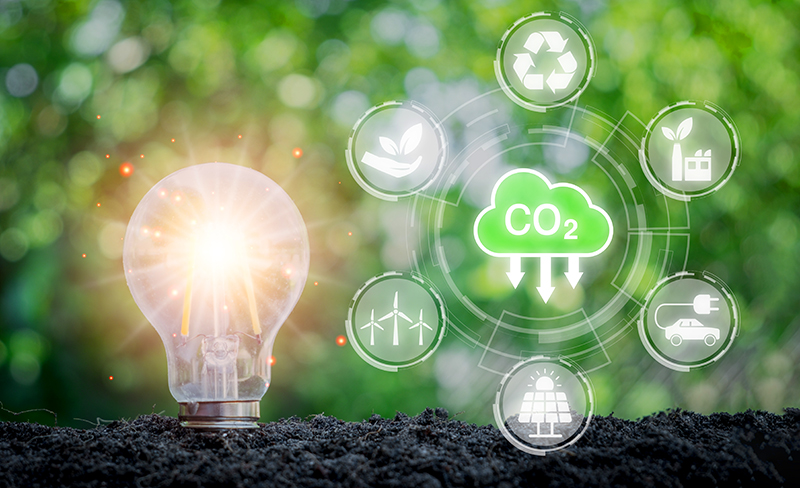 Image of Reducing CO2 emission concept. Light bulb on soil with CO2 icon on virtual screen, Sustainable development and green business based on renewable energy, electric transport.